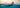 Split underwater/over-water view of ocean swimming, navy rashguard visible through the divide.