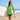 Model wearing the green long sleeve rash guard on a sunny beach