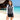 Model wearing the gray and white zip-front diving swim set on a sunny beach