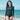 Model wearing the SAILBEE women\'s long-sleeve split diving swim set on a sunny beach